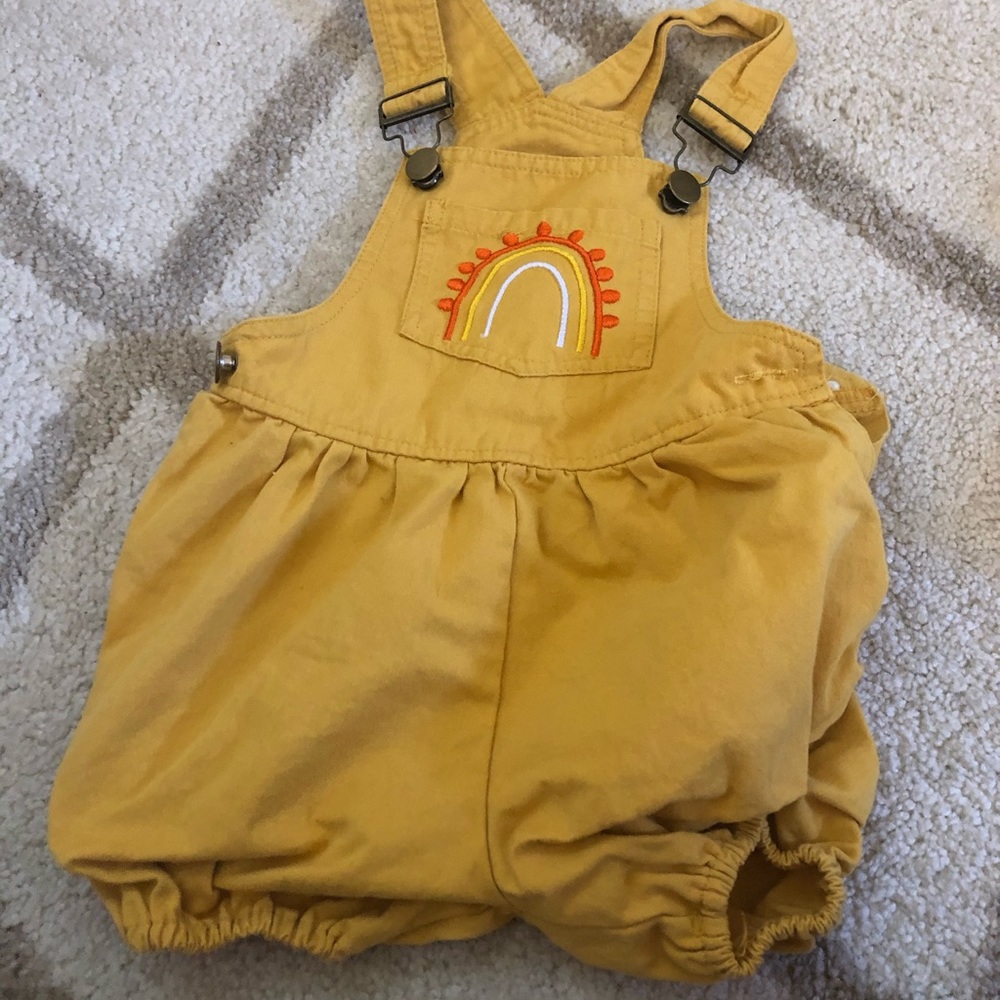 Mustard yellow rainbow overalls.